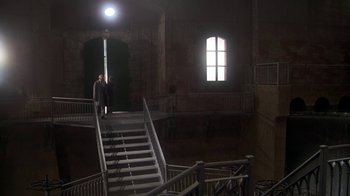 Movie still from “Marathon Man” (1976), directed by John Schlesinger – A man walking up a set of stairs in a building; Extreme Wide shot, High angle