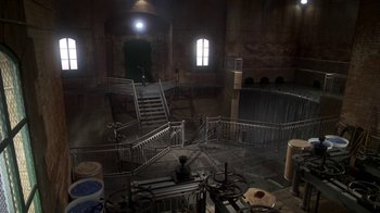 Movie still from “Marathon Man” (1976), directed by John Schlesinger – A dark room with stairs leading up to a window; Extreme Wide shot, High angle