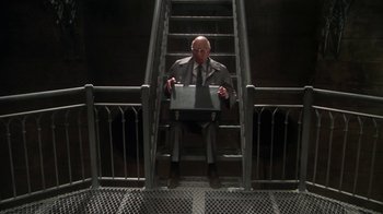 Movie still from “Marathon Man” (1976), directed by John Schlesinger – A man in a suit and tie holding a briefcase; Wide shot, Low angle