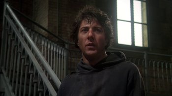 Movie still from “Marathon Man” (1976), directed by John Schlesinger – A man in a black hoodie standing in front of a staircase; Close Up shot, Low angle