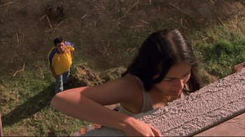 Movie still from “Maria Full of Grace” (2004), directed by Joshua Marston – A young woman is standing on the side of a hill; Medium shot, Low angle