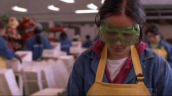 Movie still from “Maria Full of Grace” (2004), directed by Joshua Marston – A woman wearing goggles and an apron; Close Up shot, Low angle