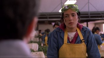Movie still from “Maria Full of Grace” (2004), directed by Joshua Marston – A woman wearing goggles and an apron in a market; Close Up shot, Over the shoulder angle