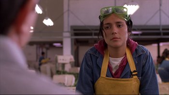 Movie still from “Maria Full of Grace” (2004), directed by Joshua Marston – A woman wearing goggles and an apron in an industrial setting; Close Up shot, Low angle