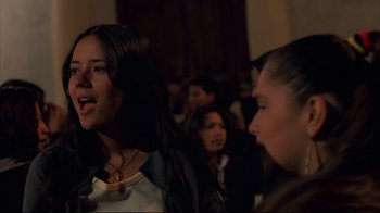 Movie still from “Maria Full of Grace” (2004), directed by Joshua Marston – A group of young people standing in front of a crowd; Close Up shot, Low angle