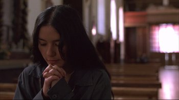 Movie still from “Maria Full of Grace” (2004), directed by Joshua Marston – A woman is praying in a church with her eyes closed; Close Up shot, Low angle