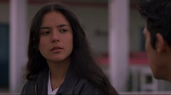 Movie still from “Maria Full of Grace” (2004), directed by Joshua Marston – A woman with long black hair is looking at the camera; Close Up shot, Over the shoulder angle