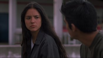 Movie still from “Maria Full of Grace” (2004), directed by Joshua Marston – A young woman looking at a young man in front of a building; Close Up shot, Over the shoulder angle