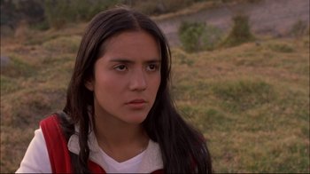 Movie still from “Maria Full of Grace” (2004), directed by Joshua Marston – A young woman with long hair is standing in a field; Close Up shot, High angle