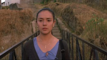 Movie still from “Maria Full of Grace” (2004), directed by Joshua Marston – A woman standing in front of some stairs; Close Up shot, Low angle