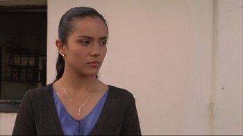 Movie still from “Maria Full of Grace” (2004), directed by Joshua Marston – A young woman wearing a blue shirt and a black jacket; Close Up shot, High angle