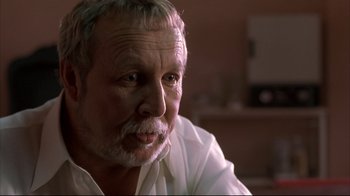 Movie still from “Maria Full of Grace” (2004), directed by Joshua Marston – An older man wearing a white dress shirt; Close Up shot, Low angle