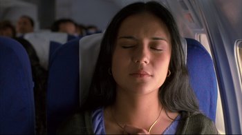 Movie still from “Maria Full of Grace” (2004), directed by Joshua Marston – A woman is sleeping on a seat on an airplane; Close Up shot, High angle