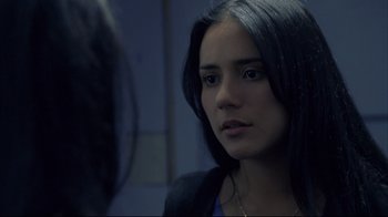 Movie still from “Maria Full of Grace” (2004), directed by Joshua Marston – A woman with long black hair looking into a mirror; Close Up shot, Over the shoulder angle