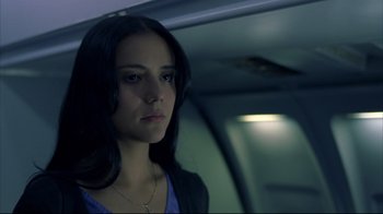 Movie still from “Maria Full of Grace” (2004), directed by Joshua Marston – A woman with long black hair standing in a dark room; Close Up shot, Low angle