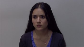 Movie still from “Maria Full of Grace” (2004), directed by Joshua Marston – A woman with long black hair wearing a blue shirt; Close Up shot, Over the shoulder angle