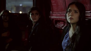 Movie still from “Maria Full of Grace” (2004), directed by Joshua Marston – Two young people standing next to each other in front of a red van; Close Up shot, Low angle