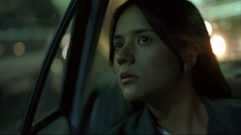 Movie still from “Maria Full of Grace” (2004), directed by Joshua Marston – A woman sitting in the driver's seat of a car; Close Up shot, Low angle