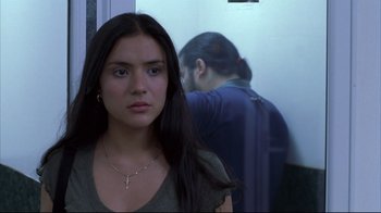 Movie still from “Maria Full of Grace” (2004), directed by Joshua Marston – A woman standing in front of a person in a room; Close Up shot, Over the shoulder angle