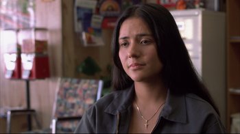 Movie still from “Maria Full of Grace” (2004), directed by Joshua Marston – A woman with long black hair is wearing a necklace; Close Up shot, Over the shoulder angle