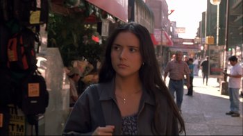Movie still from “Maria Full of Grace” (2004), directed by Joshua Marston – A woman is walking down the street in a city; Close Up shot, Low angle