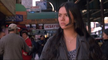 Movie still from “Maria Full of Grace” (2004), directed by Joshua Marston – A woman with long black hair standing on a city street; Close Up shot, Low angle