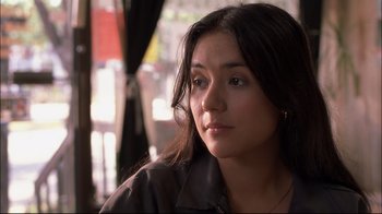 Movie still from “Maria Full of Grace” (2004), directed by Joshua Marston – A person sitting in front of a window; Close Up shot, Over the shoulder angle