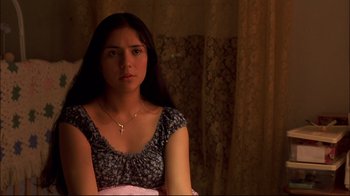 Movie still from “Maria Full of Grace” (2004), directed by Joshua Marston – A woman with long dark brown hair wearing a dress; Close Up shot, Over the shoulder angle