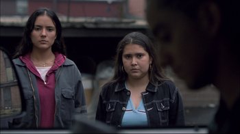 Movie still from “Maria Full of Grace” (2004), directed by Joshua Marston – Two women standing next to each other on a street; Medium shot, Over the shoulder angle