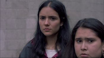 Movie still from “Maria Full of Grace” (2004), directed by Joshua Marston – Two young women standing next to each other in front of a brick wall; Close Up shot, Low angle