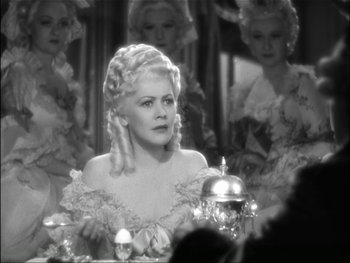 Movie still from “Marie Antoinette” (1938), directed by Julien Duvivier – A black - and - white photo of a woman in an old movie scene; Medium shot, Over the shoulder angle