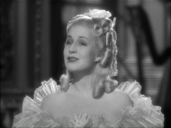 Movie still from “Marie Antoinette” (1938), directed by Julien Duvivier – A black and white photo of a woman in a dress; Close Up shot, High angle