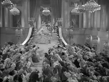 Movie still from “Marie Antoinette” (1938), directed by Julien Duvivier – An old photo of a crowd of people sitting on a staircase; Extreme Wide shot, High angle