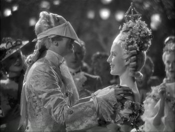 Movie still from “Marie Antoinette” (1938), directed by Julien Duvivier – A man and a woman dressed up in costumes; Medium shot, High angle