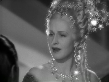 Movie still from “Marie Antoinette” (1938), directed by Julien Duvivier – A black and white photo of a woman in a costume; Close Up shot, Over the shoulder angle