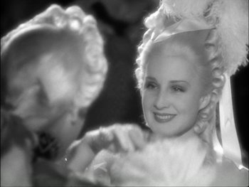 Movie still from “Marie Antoinette” (1938), directed by Julien Duvivier – An old black and white photo of a woman in a wig; Close Up shot, Over the shoulder angle