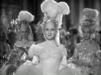Movie still from “Marie Antoinette” (1938), directed by Julien Duvivier – A group of women dressed up in fancy costumes; Medium shot, Over the shoulder angle