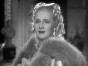 Movie still from “Marie Antoinette” (1938), directed by Julien Duvivier – An old photo of a woman in a fur coat; Close Up shot, Over the shoulder angle