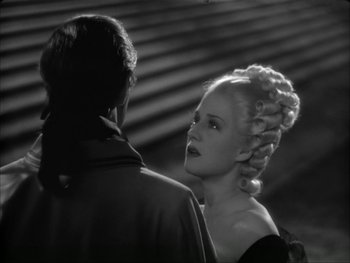 Movie still from “Marie Antoinette” (1938), directed by Julien Duvivier – A man and a woman standing next to each other; Close Up shot, Over the shoulder angle