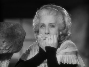 Movie still from “Marie Antoinette” (1938), directed by Julien Duvivier – An older woman is holding her hands to her mouth; Close Up shot, Low angle