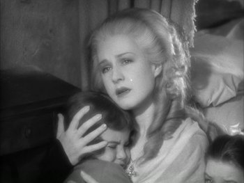 Movie still from “Marie Antoinette” (1938), directed by Julien Duvivier – An old photo of a woman holding a child; Close Up shot, High angle
