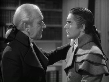 Movie still from “Marie Antoinette” (1938), directed by Julien Duvivier – A man and a man in black and white photo; Medium shot, Over the shoulder angle