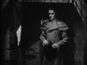 Movie still from “Marie Antoinette” (1938), directed by Julien Duvivier – A black and white photo of a man in a uniform; Medium shot, Low angle