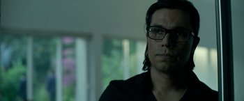 Movie still from “Extraction” (2020), directed by Sam Hargrave – A person wearing glasses; Close Up shot, Low angle