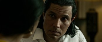 Movie still from “Extraction” (2020), directed by Sam Hargrave – A person with long hair; Close Up shot, Over the shoulder angle