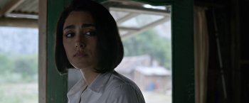 Movie still from “Extraction” (2020), directed by Sam Hargrave – A person wearing a white shirt; Close Up shot, Over the shoulder angle