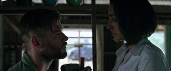 Movie still from “Extraction” (2020), directed by Sam Hargrave – A man and a woman face to face in a room; Close Up shot, Low angle