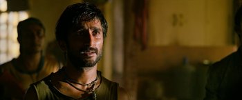 Movie still from “Extraction” (2020), directed by Sam Hargrave – A person with a beard; Close Up shot, Low angle