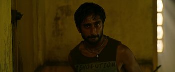 Movie still from “Extraction” (2020), directed by Sam Hargrave – A person wearing a tank top; Close Up shot, Low angle