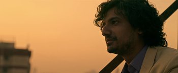 Movie still from “Extraction” (2020), directed by Sam Hargrave – A person with long hair; Close Up shot, Low angle